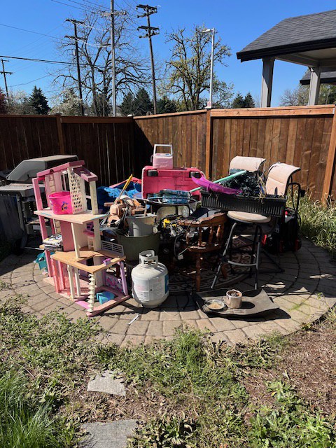 Patio furniture and household items before removal.
