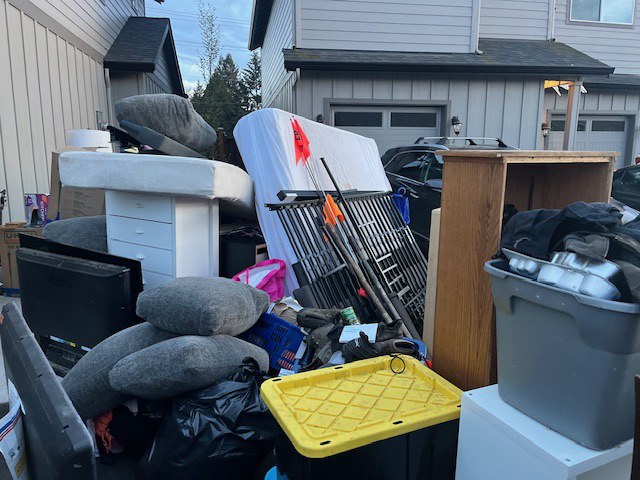 Household items and furniture gathered for removal.